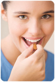 Teenage girl taking vitamin